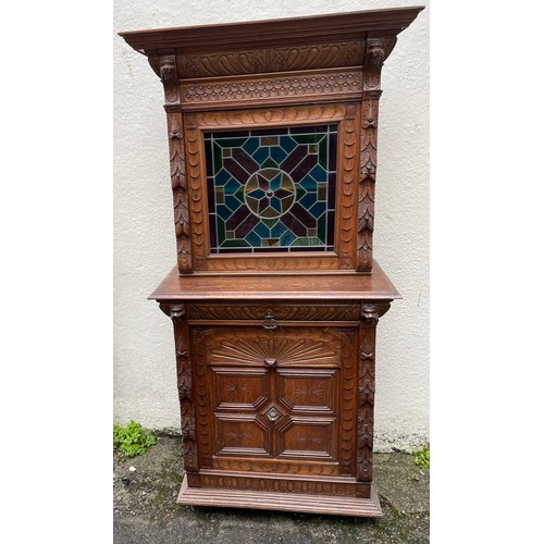 57 - Continental Two Piece Carved Wood Hunt Cupboard With Glazed Panel. 191 x 90 x 48 cms.