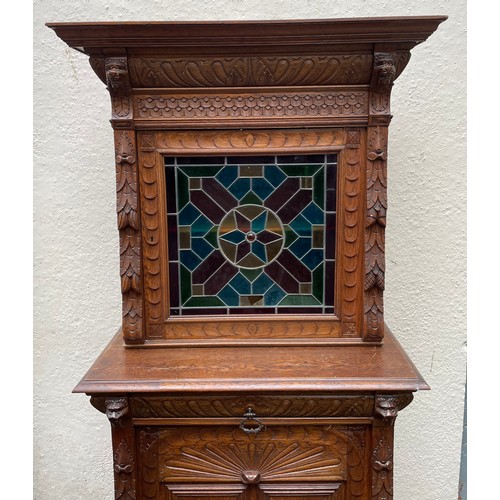 57 - Continental Two Piece Carved Wood Hunt Cupboard With Glazed Panel. 191 x 90 x 48 cms.