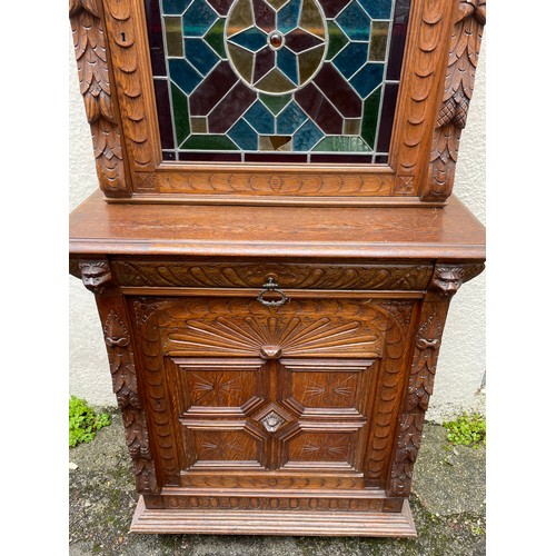 57 - Continental Two Piece Carved Wood Hunt Cupboard With Glazed Panel. 191 x 90 x 48 cms.