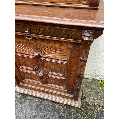 57 - Continental Two Piece Carved Wood Hunt Cupboard With Glazed Panel. 191 x 90 x 48 cms.