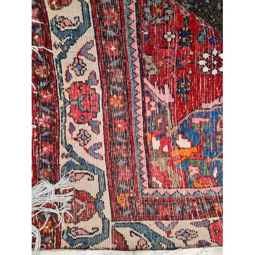 95 - Hand Knotted Red ground Rug with Diamond Centre, 165cm x 115cm