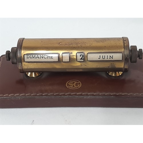 32 - Brass Perpetual Calendar on leather covered base, 15cm x 6cm