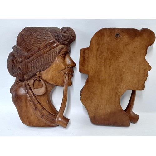 43 - 2 x Wood Carved ladies heads smoking a pipe, 26cm x 18cm