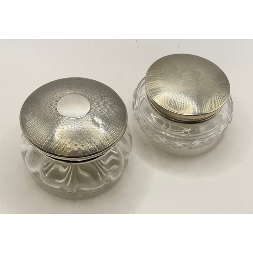 252 - Two Cut Glass Jars With Decorated Hallmarked Silver Lids. Silver Weight 1.935 Oz. Largest 10cm Diame... 