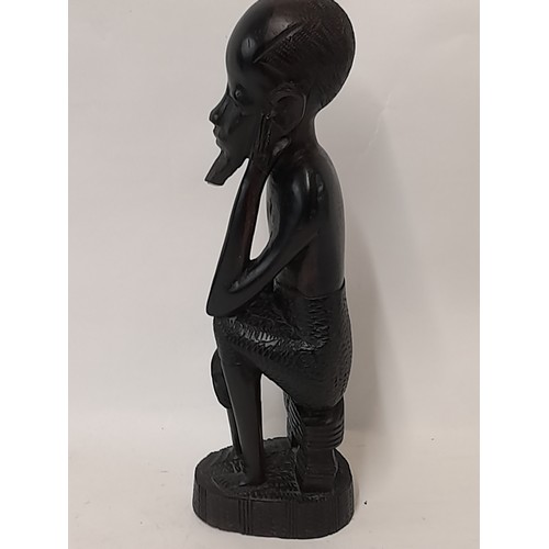 97 - Tribal wood carved Seated Man, 28cm high