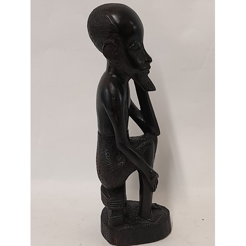 97 - Tribal wood carved Seated Man, 28cm high