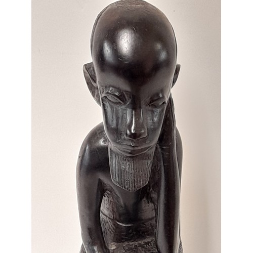 97 - Tribal wood carved Seated Man, 28cm high