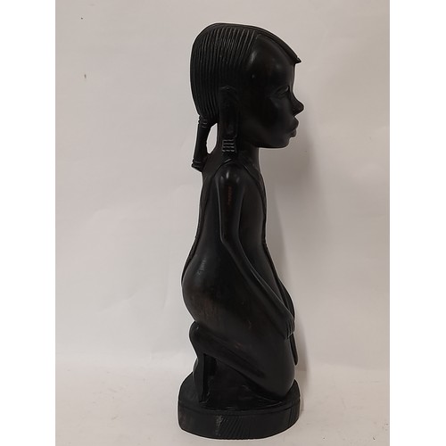 98 - Tribal wood carved figure of a kneeling woman, 37cm high