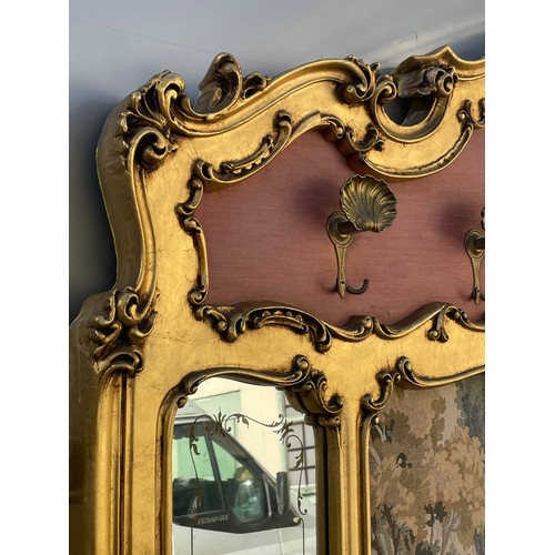 26 - Large Gilt  Mirror With Coat Hooks With A Needlepoint Tapestry Centre. Measures 6 Foot 8 Inches Wide... 