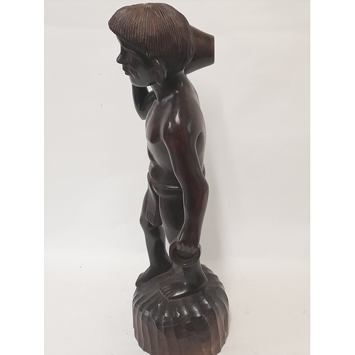 316 - Carved wood Tribesman carrying a vessel on his shoulder, 51cm high