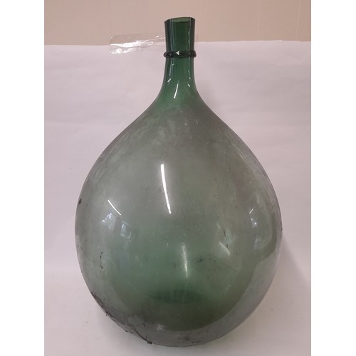 317 - Large Green Glass Carboy in plastic container, approximately 62cm high x 42cm wide