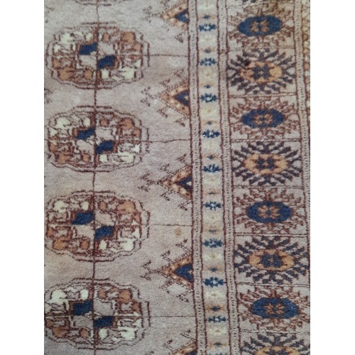 443 - Small brown ground rug with central lozenges, 95cm x 62cm