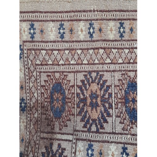 443 - Small brown ground rug with central lozenges, 95cm x 62cm