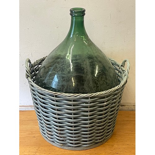 305 - Large Glass Carboy / Demijohn In Basket. 65 x 48 cms