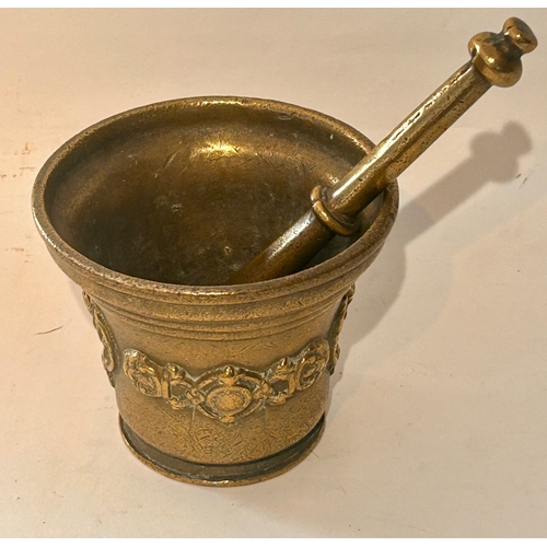 407 - Antique Brass Mortar and pestle lug handled with crest around. 13cm x 16cm