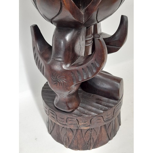 356 - Large Tribal Carving depicting two cattle heads and a bowl carved in the top, 62cm high