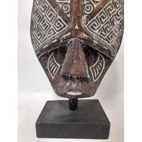 366 - Decorative Carved Tribal mask on stand, 52cm high