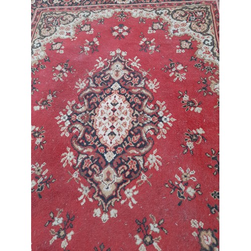 420 - Red Ground rug with Gold pattern and medallion, 176cm x 139cm