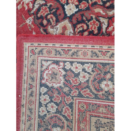 420 - Red Ground rug with Gold pattern and medallion, 176cm x 139cm