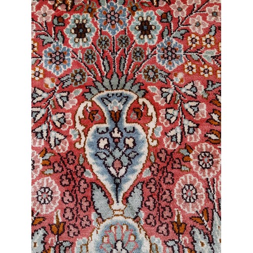 83 - Oriental rug with floral pattern, 92cm x 62cm
