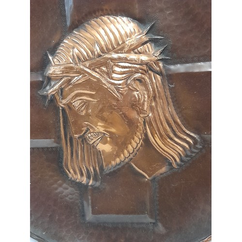 425 - Copper and Brass wall Plaque depicting the Head of Christ, 38cm diameter