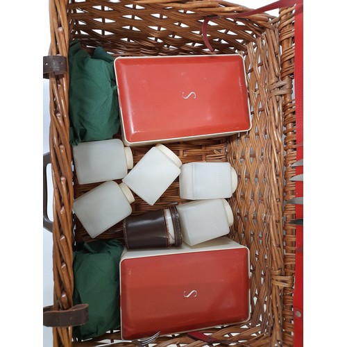 493 - Wicker picnic set with original contents, with a tin tray on folding legs