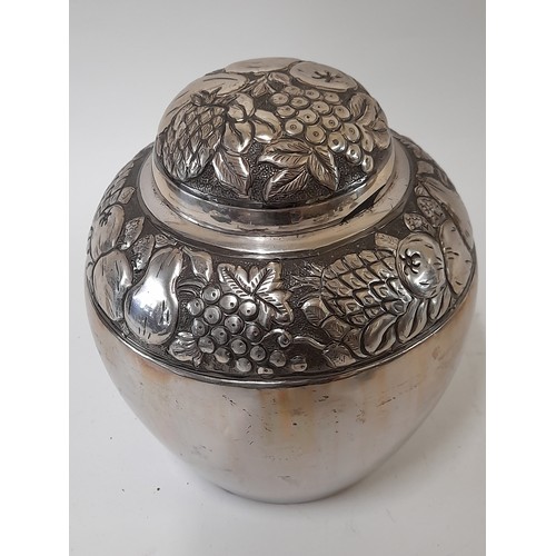 376 - Polished White Metal Lidded container with Raised Fruit Design, 19cm high