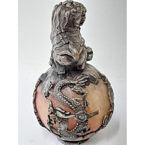 377 - A Pair of Oriental Brass Dragon stood on a ball encapsulated in an intricate metal design. 6cm high.