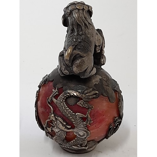 377 - A Pair of Oriental Brass Dragon stood on a ball encapsulated in an intricate metal design. 6cm high.