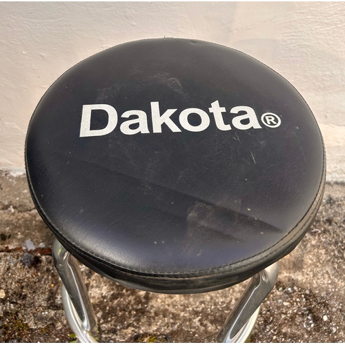 719 - Metal work Stool  advertising Dakota. 73cm x 46cm.