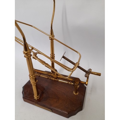 585 - Mechanical Brass Wine Decanter on wooden Plinth, 40cm x 38cm