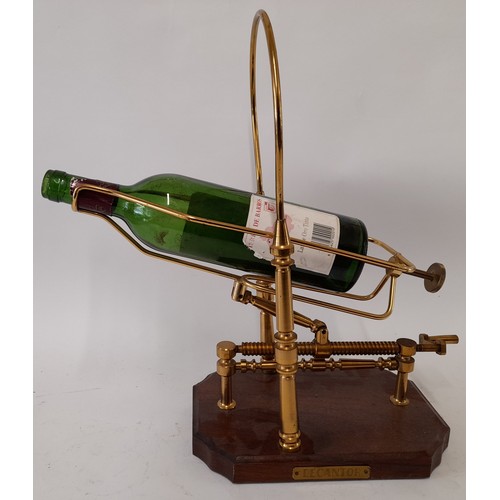 585 - Mechanical Brass Wine Decanter on wooden Plinth, 40cm x 38cm