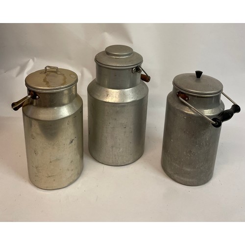 55 - Three Vintage Aluminium Lidded Milk Jugs. Largest 32 cms High