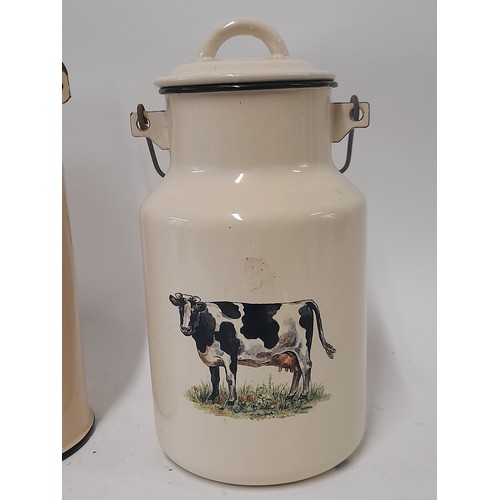 626 - 2 x White Enamel Milk Churns, one with picture of a Cow, 26cm high. the larger 28cm high. Both with ... 