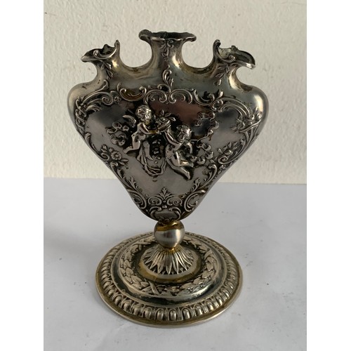 63 - Unmarked Silver Métal 19thC Heart Shaped Tulip Bud Vase With Raised Floral And Cupid Relief
98.2g
9 ... 