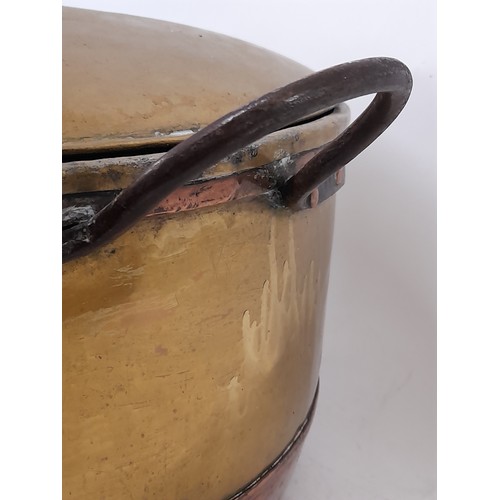 98 - Large brass and copper cooking vessel with lid and 2 iron side handles, 35cm high x 49cm high