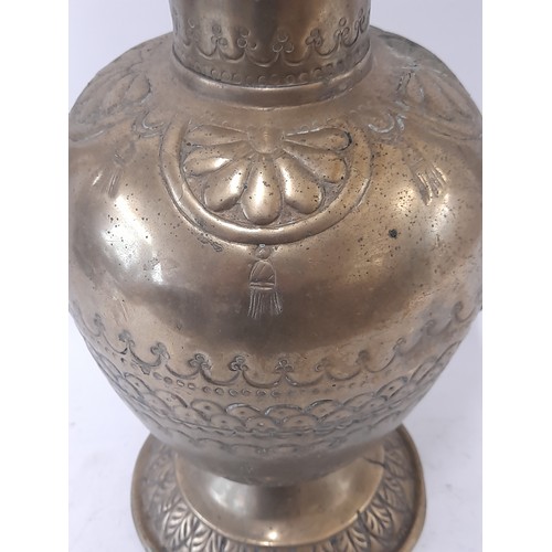 103 - Brass water Jug with lid and Repousse decoration, 38cm high x 31cm wide