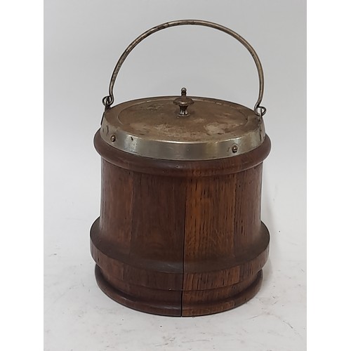 115 - Oak Biscuit Barrel with lid and swing handle, blank Cartouche shield to front, 15cm high