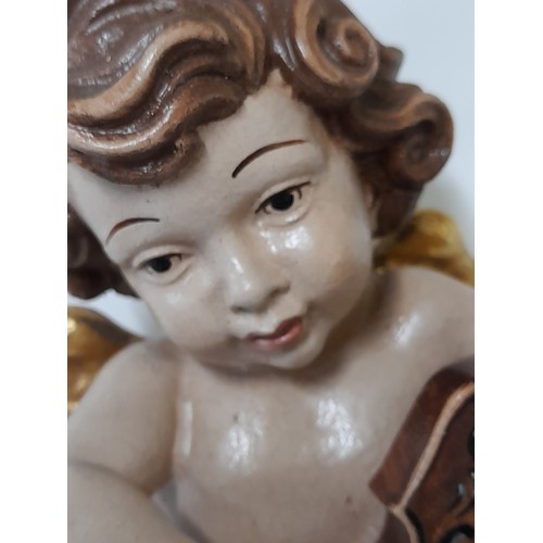 38 - Composite Winged Cherub Figure, 24cm high