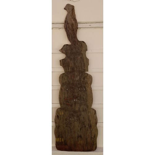 209 - Carved and shaped plank of wood possibly South Asian with signs of original paint. 145cm x 42cm