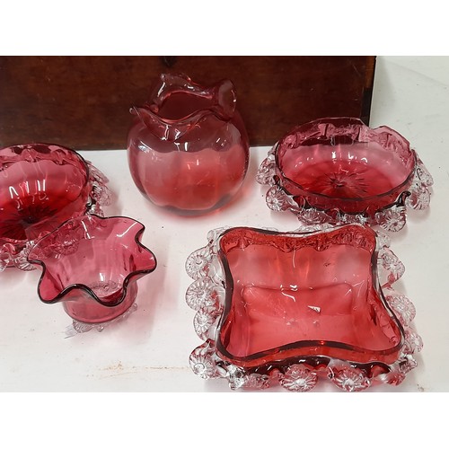 214 - 7 x items of Cranberry Glass (some with damage) contained in a wooden box, 34cm x 16cm x 17cm