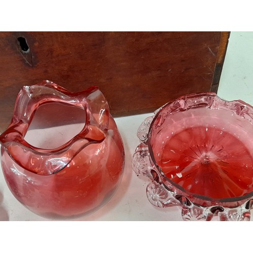 214 - 7 x items of Cranberry Glass (some with damage) contained in a wooden box, 34cm x 16cm x 17cm