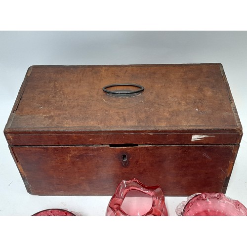 214 - 7 x items of Cranberry Glass (some with damage) contained in a wooden box, 34cm x 16cm x 17cm