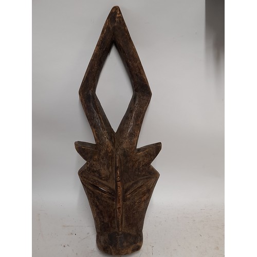 563 - Tribal Hand carved Face Mask in the form of a horned animal, 57cm x 21cm