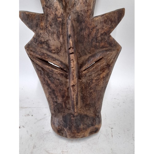 563 - Tribal Hand carved Face Mask in the form of a horned animal, 57cm x 21cm