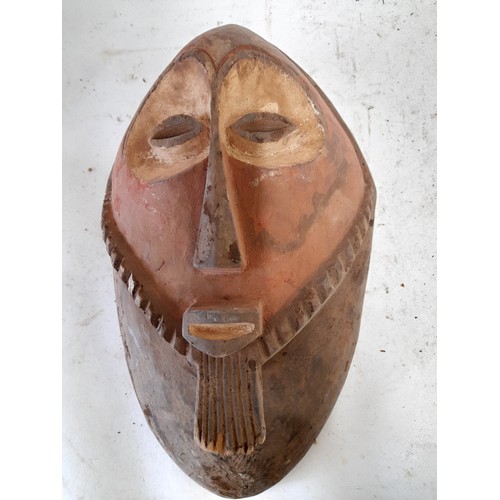 568 - Tribal Hand carved Face Mask with red face and white eyes, 36cm x 21cm