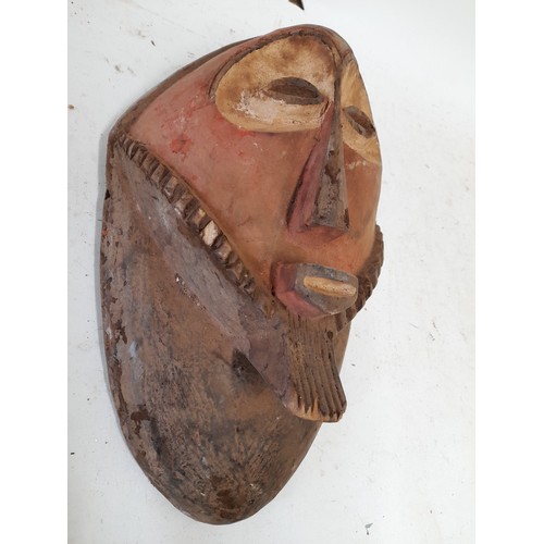 568 - Tribal Hand carved Face Mask with red face and white eyes, 36cm x 21cm