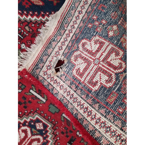 11A - Hand Knotted Red Ground Rug with wear, 140cm x 76cm