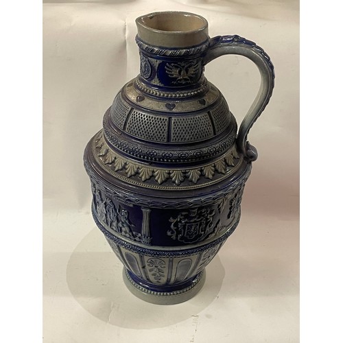 24 - German Salt glaze Pitcher With Decoration. 31.5 cms High