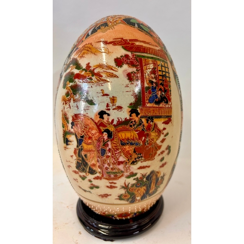 270 - Decorative Oriental Ceramic Hand painted Egg On Wooden Plinth. 24cm x 13cm.